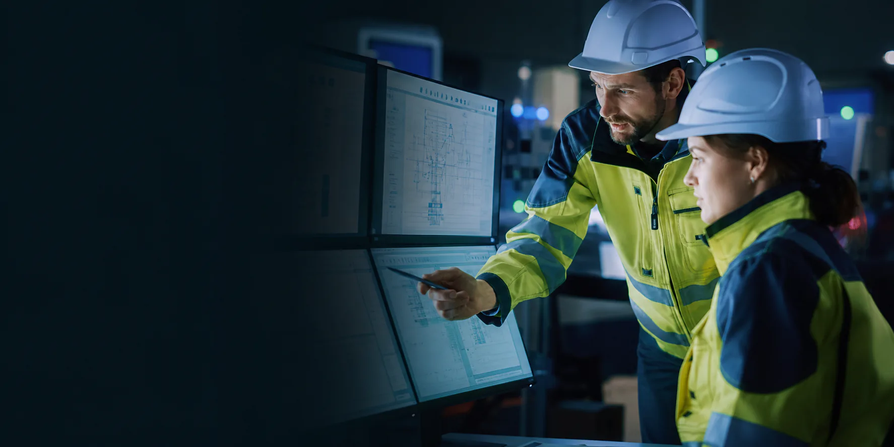 Two environmental monitoring specialists reviewing data in a control room